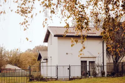 a white house with a fence in front of it at Weekend Joy Home in Visoko