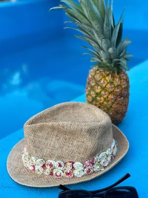 a straw hat and a pineapple on a blue table at Weekend Joy Home in Visoko