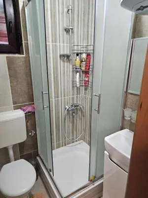 a shower in a bathroom with a toilet and a sink at Apartman Slapovi in Krupa na Vrbasu