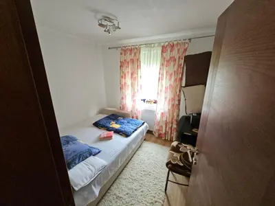a small bedroom with a bed and a window at Apartman Slapovi in Krupa na Vrbasu