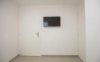 two white cabinets with a television on top of them at Pansion Kipovi in Tuzla