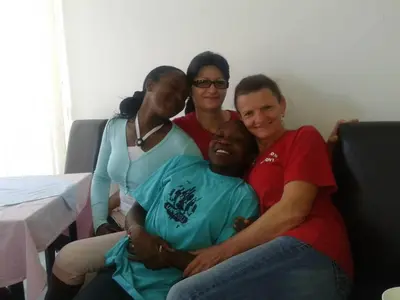 a group of three people sitting on a couch at Pansion Kipovi in Tuzla