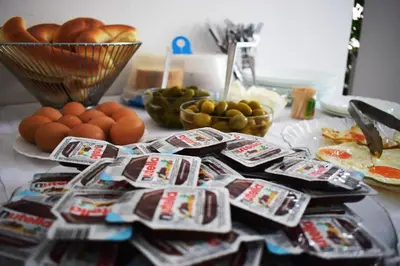 a table with a bunch of bags of food and eggs at Pansion Kipovi in Tuzla