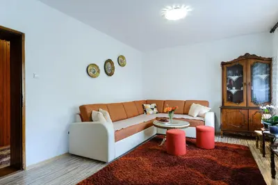 a living room with a couch and a red rug at The Cosmic Gate 3 in Biskupići