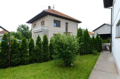 a white house with bushes in front of it at The Cosmic Gate 3 in Biskupići