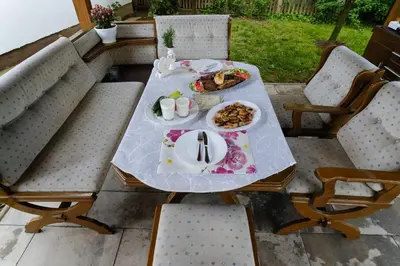 a table with a plate of food on a patio at The Cosmic Gate 3 in Biskupići