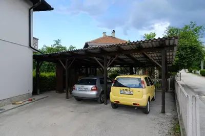 two cars parked in a parking lot next to a building at The Cosmic Gate 3 in Biskupići