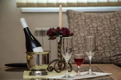 a bottle of wine and two glasses on a table at Hotel Piramida Sunca in Visoko