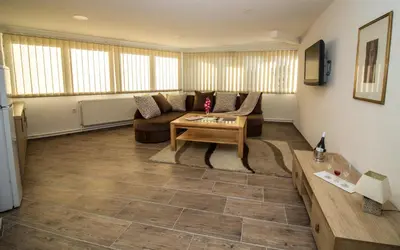a living room with a couch and a table at Hotel Piramida Sunca in Visoko
