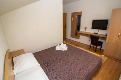 a hotel room with a bed and a desk at Hotel Piramida Sunca in Visoko