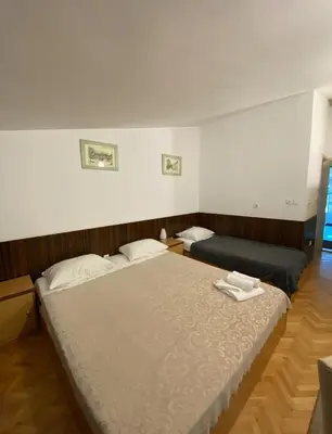 a bedroom with two beds in a room at Hotel Piramida Sunca in Visoko