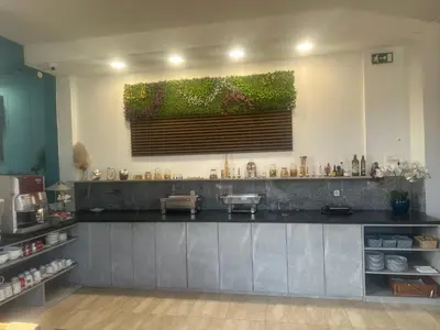 a kitchen with a counter top with a window at Hotel Piramida Sunca in Visoko