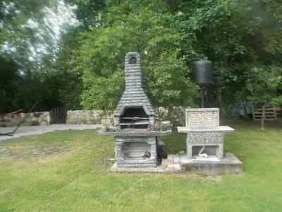 a pizza oven in the grass in a yard at Kuća za odmor V&E in Bihać