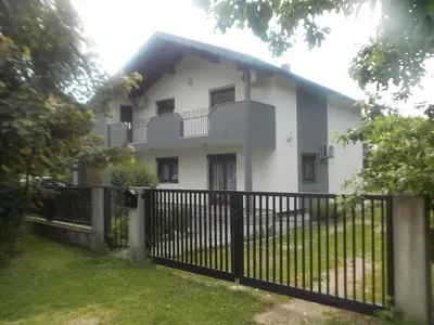 a white house with a fence in front of it at Kuća za odmor V&E in Bihać