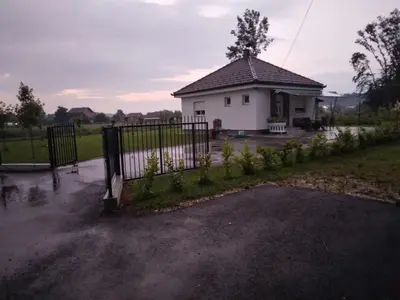 a white house with a gate in front of it at Vikendica Ninic in Laktaši