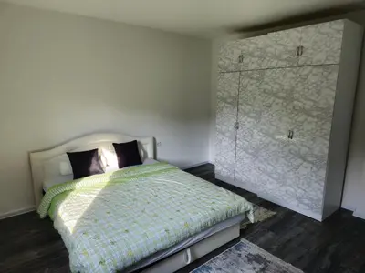 a bedroom with a bed and a large closet at Rooms Mery in Visoko