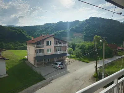 a car parked in front of a house on a street at Rooms Mery in Visoko