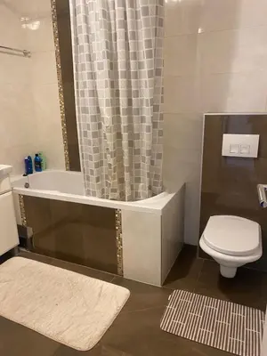 a bathroom with a tub and a toilet and a sink at Apartman AndjelA in Banja Luka