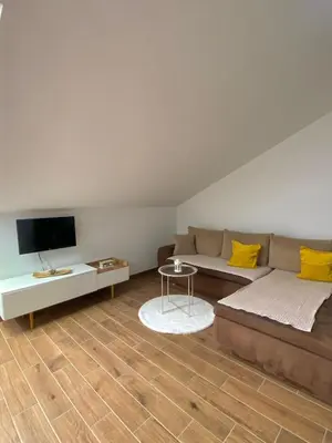 a living room with a couch and a tv at Apartman AndjelA in Banja Luka