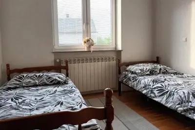 two beds sitting in a room with a window at Mia in Tomislavgrad