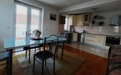 a kitchen with a table and chairs in a room at Mia in Tomislavgrad