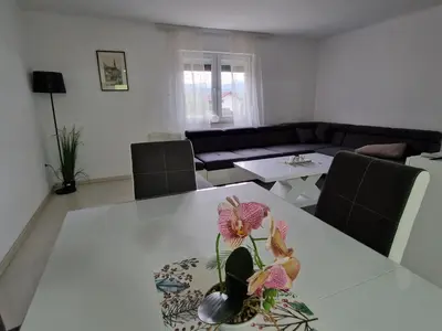 a living room with a table with a flower vase on it at Villa Sunset in Podastrana
