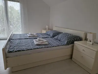a bedroom with a bed with two towels on it at Villa Sunset in Podastrana