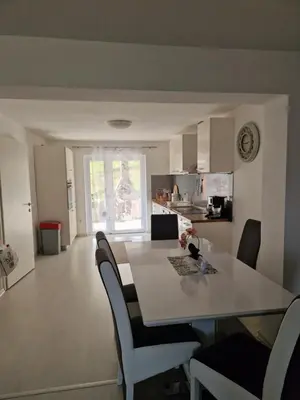 a kitchen and dining room with a table and chairs at Villa Sunset in Podastrana