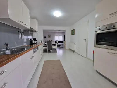 a large kitchen with white cabinets and a sink at Villa Sunset in Podastrana