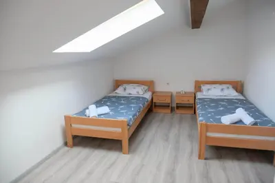 a bedroom with two beds and a skylight at Penthouse in Jajce