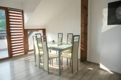 a dining room with a table and chairs at Penthouse in Jajce