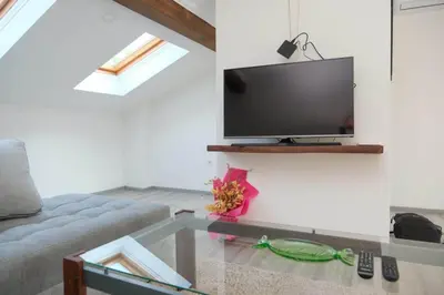 a living room with a couch and a flat screen tv at Penthouse in Jajce