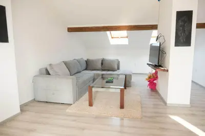 a living room with a couch and a coffee table at Penthouse in Jajce