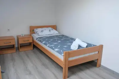 a bedroom with a bed and two night stands at Penthouse in Jajce
