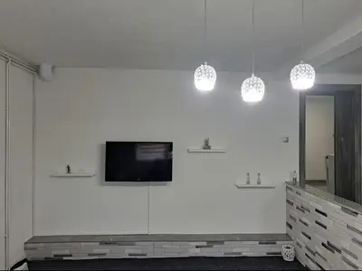 a living room with a tv on a white wall at Apartman Ivo in Livno