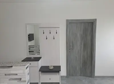 a kitchen with a door and a sink and a mirror at Apartman Ivo in Livno