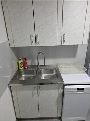 a kitchen with a stainless steel sink and cabinets at Apartman Ivo in Livno