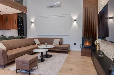 a living room with a couch and a table and a fireplace at Villa 4A Visoko in Visoko