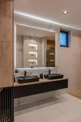 a bathroom with two sinks and a large mirror at Villa 4A Visoko in Visoko