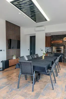 a dining room with a black table and chairs at Villa 4A Visoko in Visoko