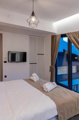 a bedroom with a large bed with a large window at Villa 4A Visoko in Visoko