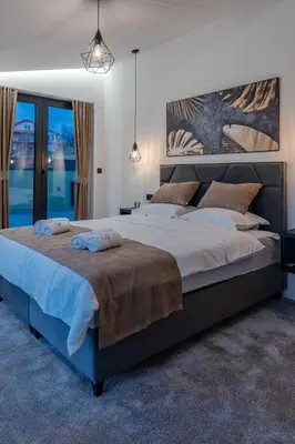 a bedroom with a large bed with two pillows on it at Villa 4A Visoko in Visoko