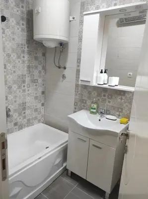 a bathroom with a sink and a tub and a toilet at Apartment Kraljevac in Visoko