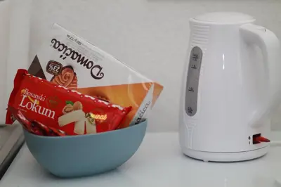 a bowl of food next to a scale and a mug at Apartment Kraljevac in Visoko