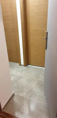 an empty room with a door and a tile floor at Old Town Central in Banja Luka