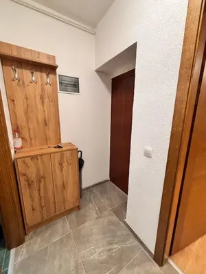 a hallway with a wooden door and a room at Old Town Central in Banja Luka