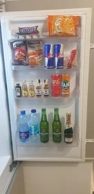 an open refrigerator filled with lots of drinks and food at Old Town Central in Banja Luka