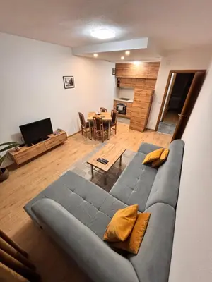 a living room with a blue couch and a table at Old Town Central in Banja Luka