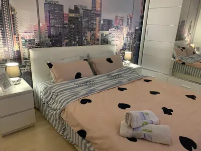 a bedroom with a bed with a large window at Apartment Sweet Home Banja Luka in Banja Luka