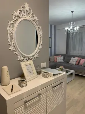 a living room with a mirror on the wall at Apartment Sweet Home Banja Luka in Banja Luka